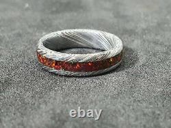 Helmskringla pattern Damascus steel ring with Ruby red opal, stainless steel dam