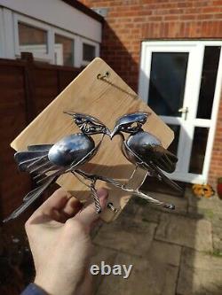 Metal bird sculpture made from recycled stainless cutlery